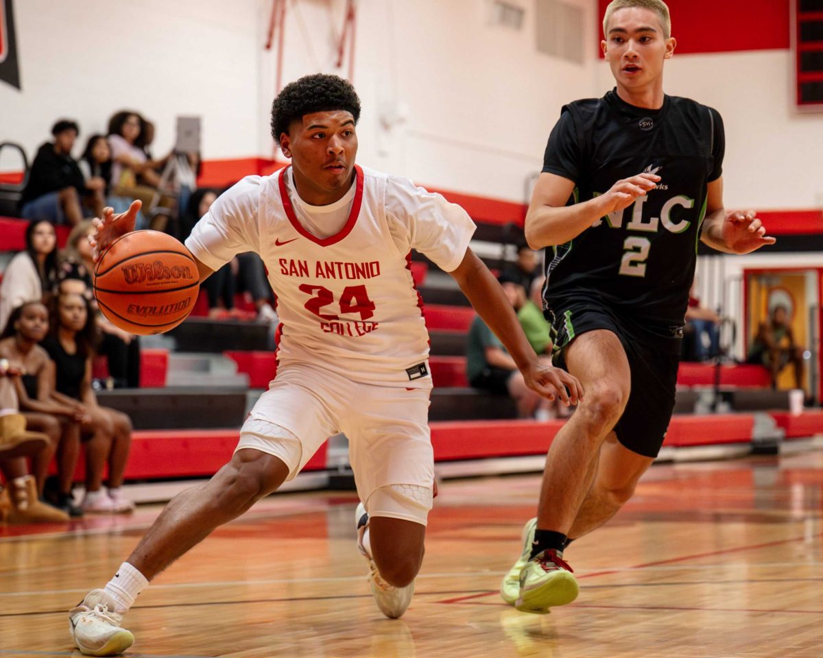 Armadillos forward Demetrice Mims drives past an NLC defender at the Candler Physical Education Center Oct. 2. Photo by A. De Leon.