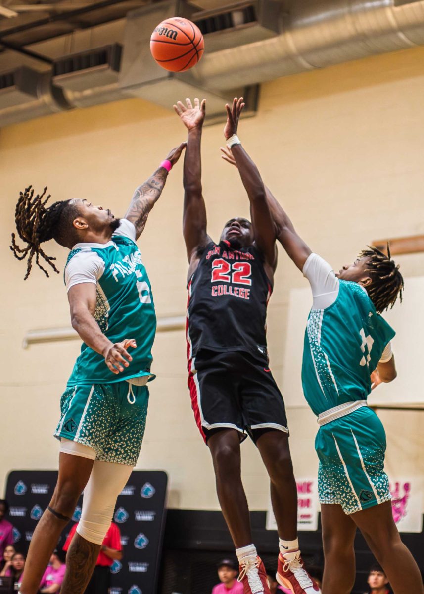 SAC guard Reggie Steadman shoots through two PAC defenders at the Abraham Kazen Middle School Gym Oct. 9. Photo by A. De Leon.