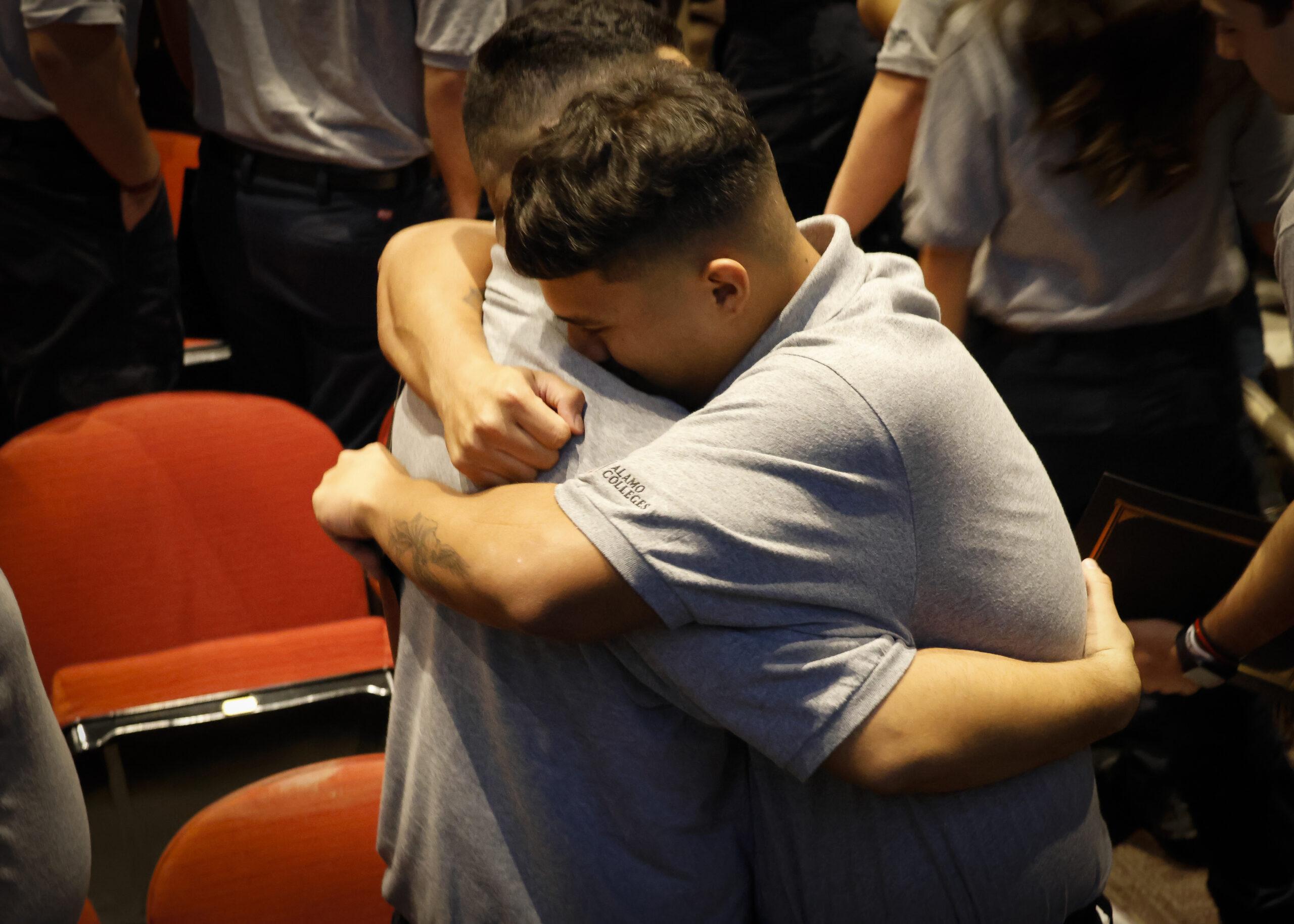 Fire Academy graduates embrace at the Fire Academy graduation ceremony at Northwest Vista College Dec. 13. Photo by Natalia Edwards.