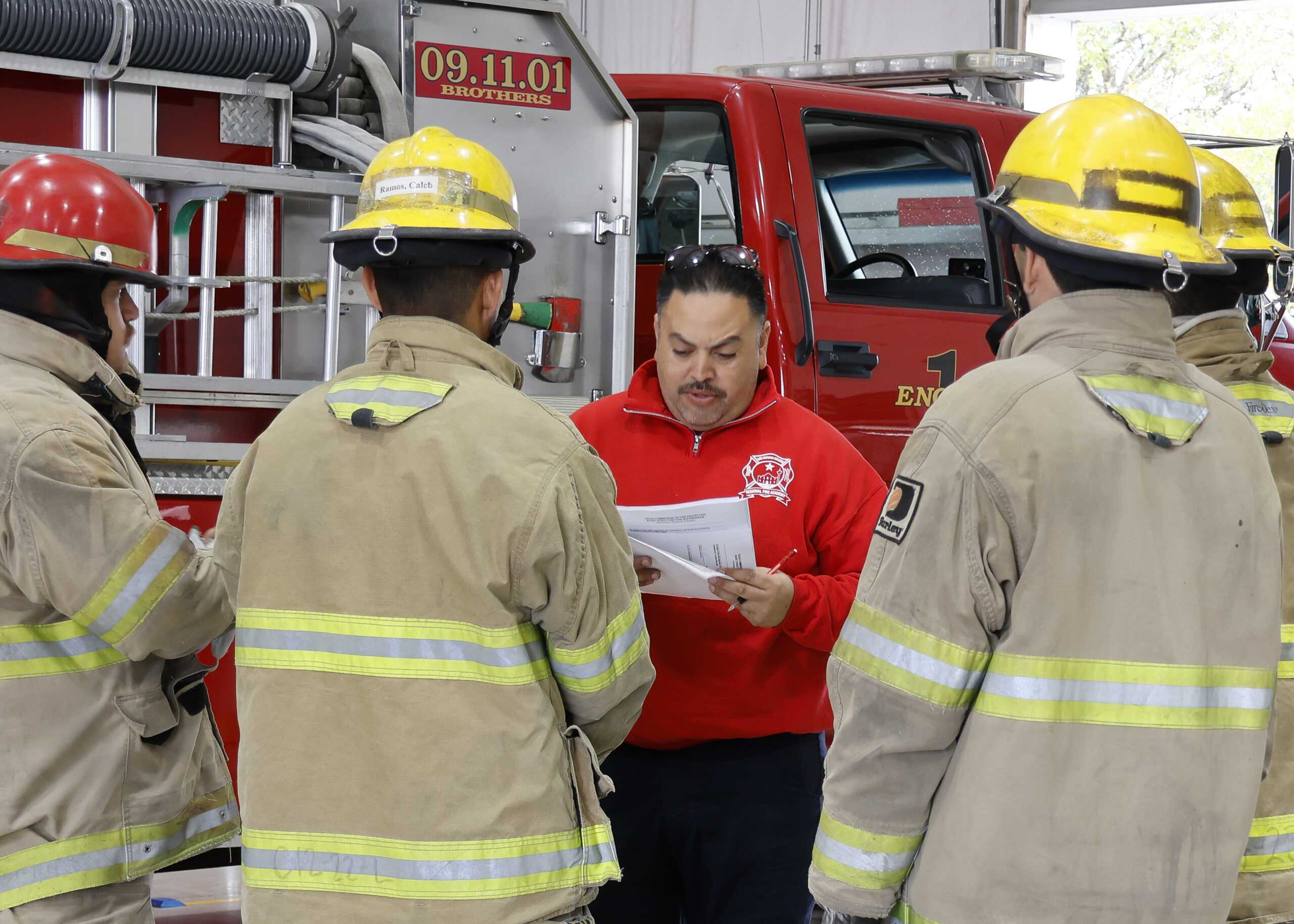 A Fire Academy instructor shares state exam results with cadets. Photo by Natalia Edwards.