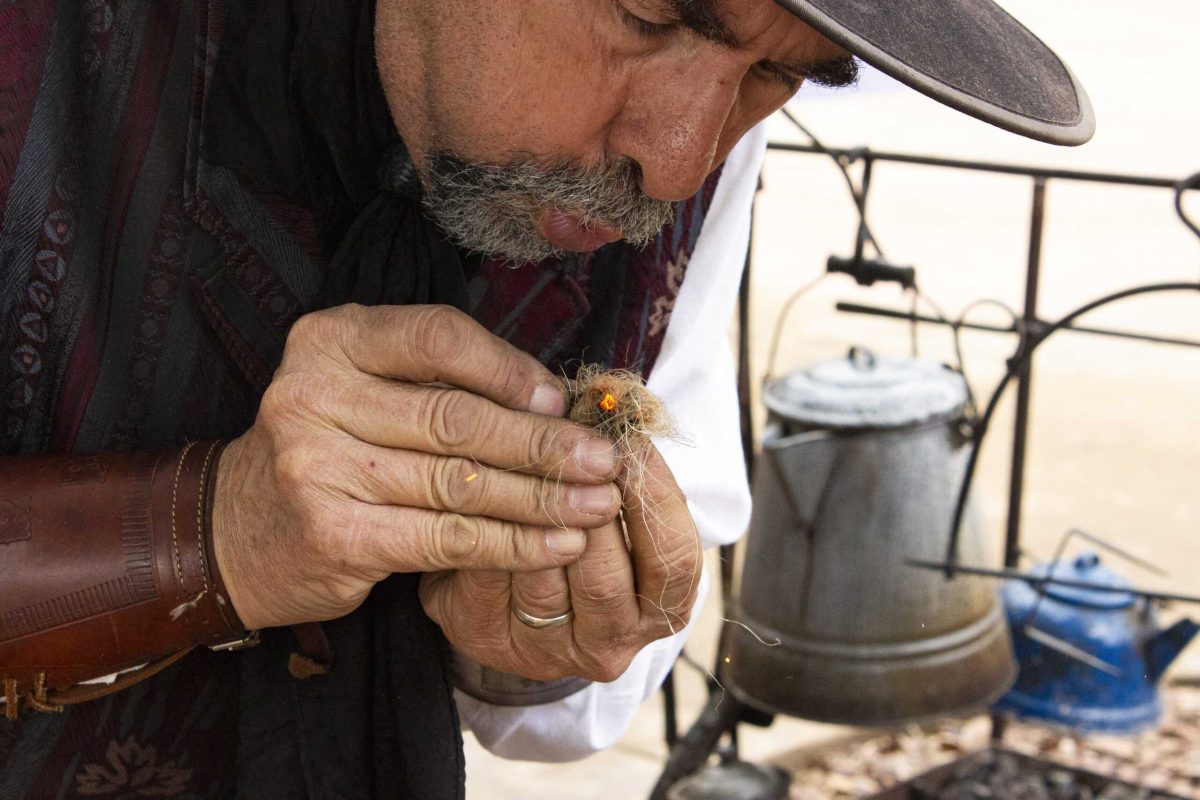 Living historian Rodney Cromeans demonstrates classic fire starting using flint, steel, and char cloth to spark a pinch of tinder for a family at the San Antonio Stock Show and Rodeo Feb. 12. Photo by Cesar A Pacheco.