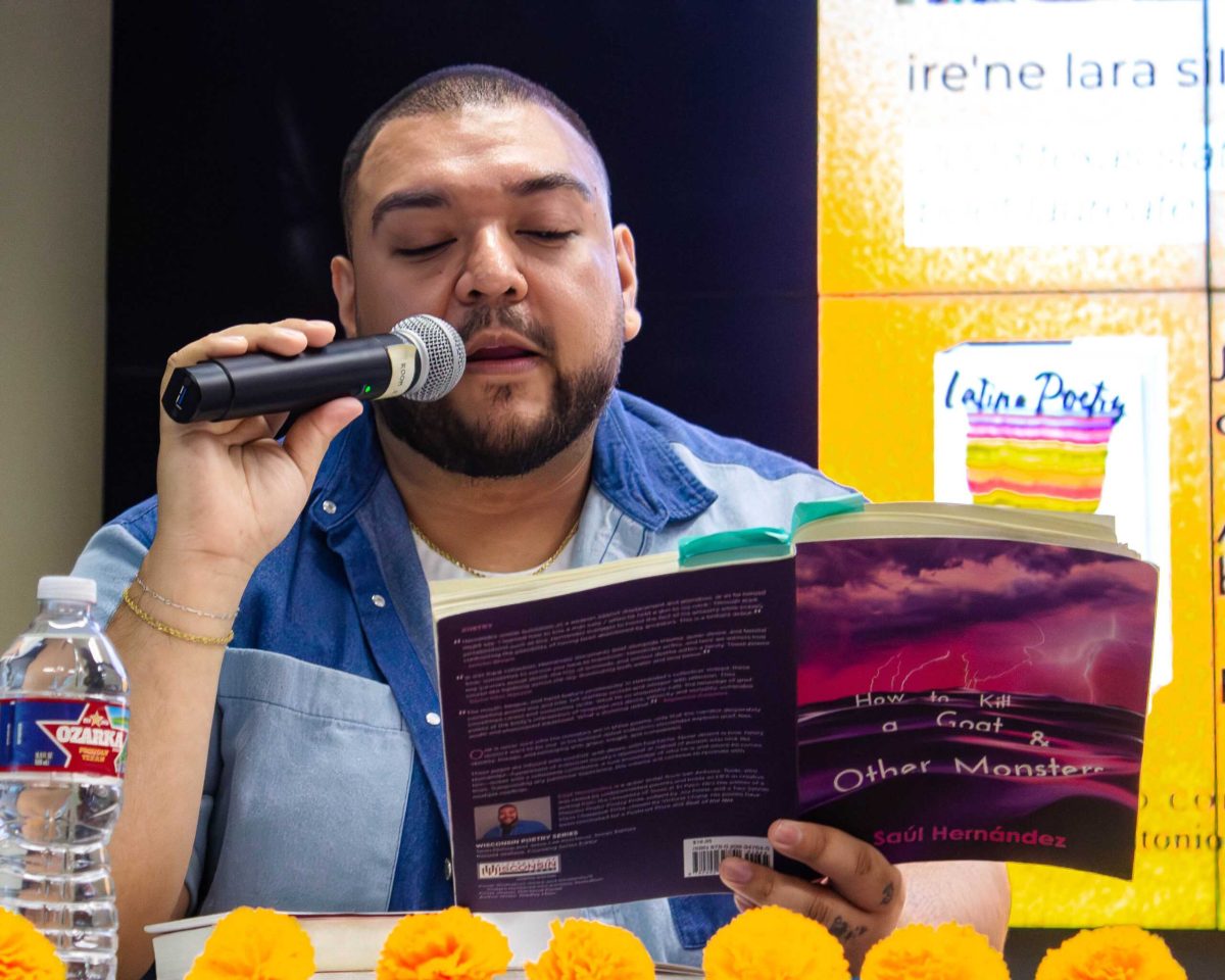 Poet Saul Hernandez, a 2025 National Endowment for the Arts Fellow, reads a poem from his book, “How to Kill a Goat and Other Monsters,” at the Nursing and Allied Heath Complex building April 15. Photo by N. Burroughs.