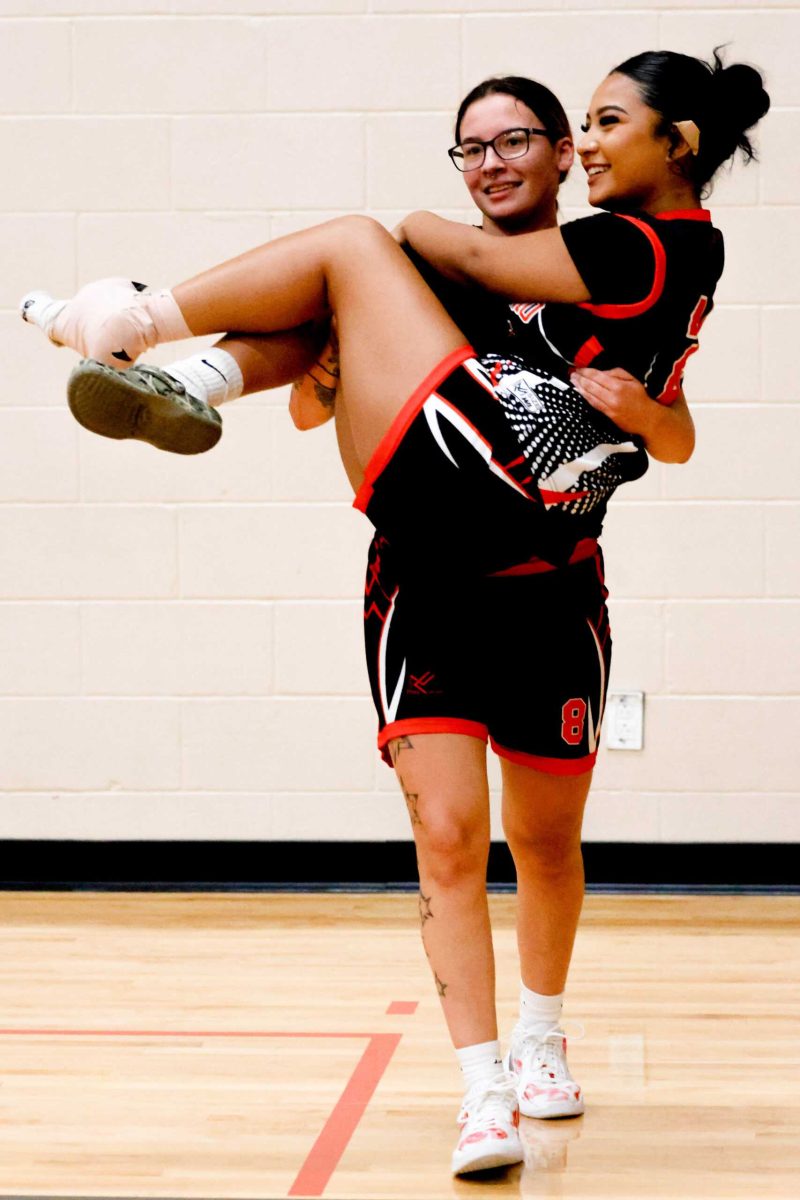SAC Forward Nevaeh Sosa carries injured teammate Isleen Juarez off the court in the second half. Photo by Janelle Alemán.