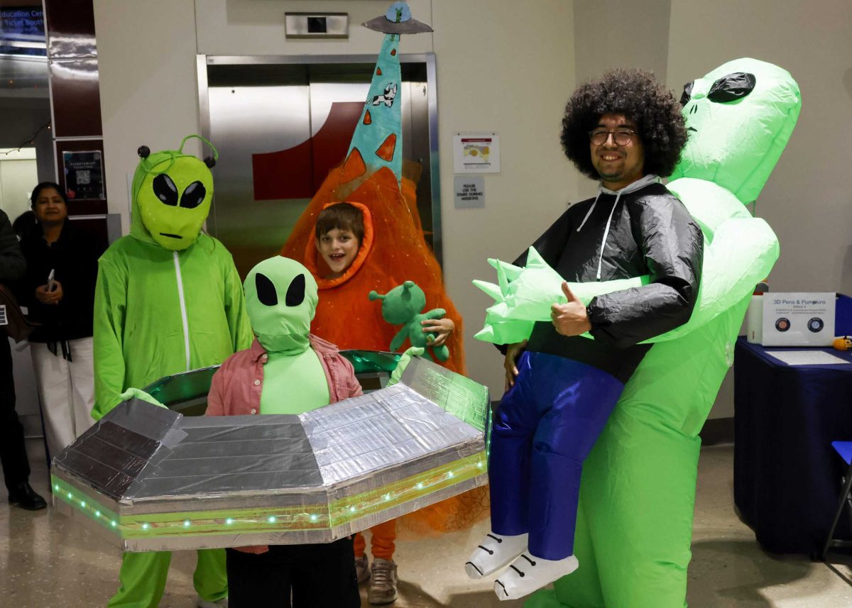 Attendees participated in a costume contest at the Scobee Education Center during the center’s Spook-tacular 11-year anniversary celebration Friday. Atticus Zozus (back left), won the contest with his Dorito costume. Photo by Samara Penny.