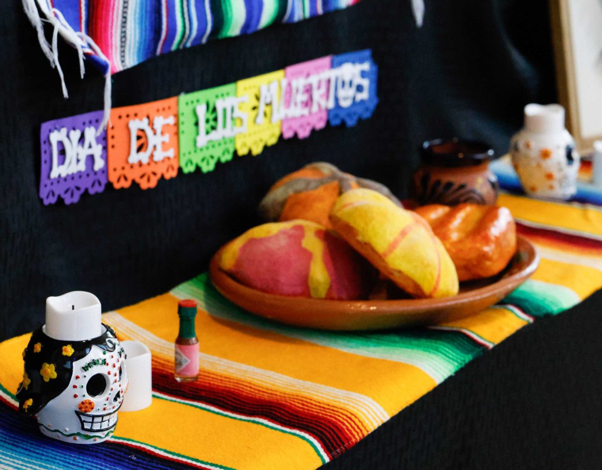 Pastries, candles and decorations sit upon an ofrenda on campus. Photo by Samara Penny.