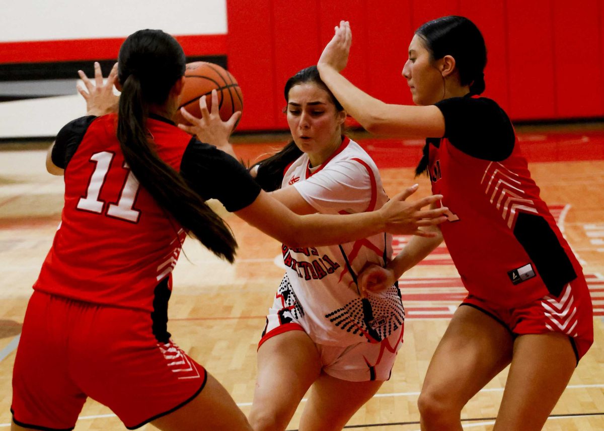 SAC Guard Casie Guy drives into UIW defenders Wednesday in SAC's fall season finale. Photo by Thomas Solis.