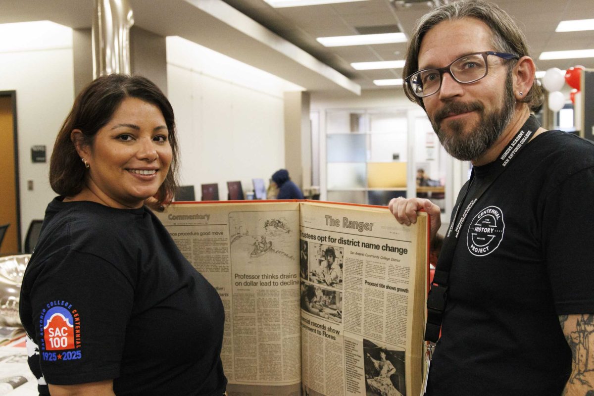 From left, Assistant Professors of History Dr. Laura Oviedo and Dr. Jecoa Ross, who coordinated the college’s Centennial Student Expo, pose Dec. 3 with archived issues of the Ranger, SAC’s student newspaper until 2020. Photo by Janelle Aleman.