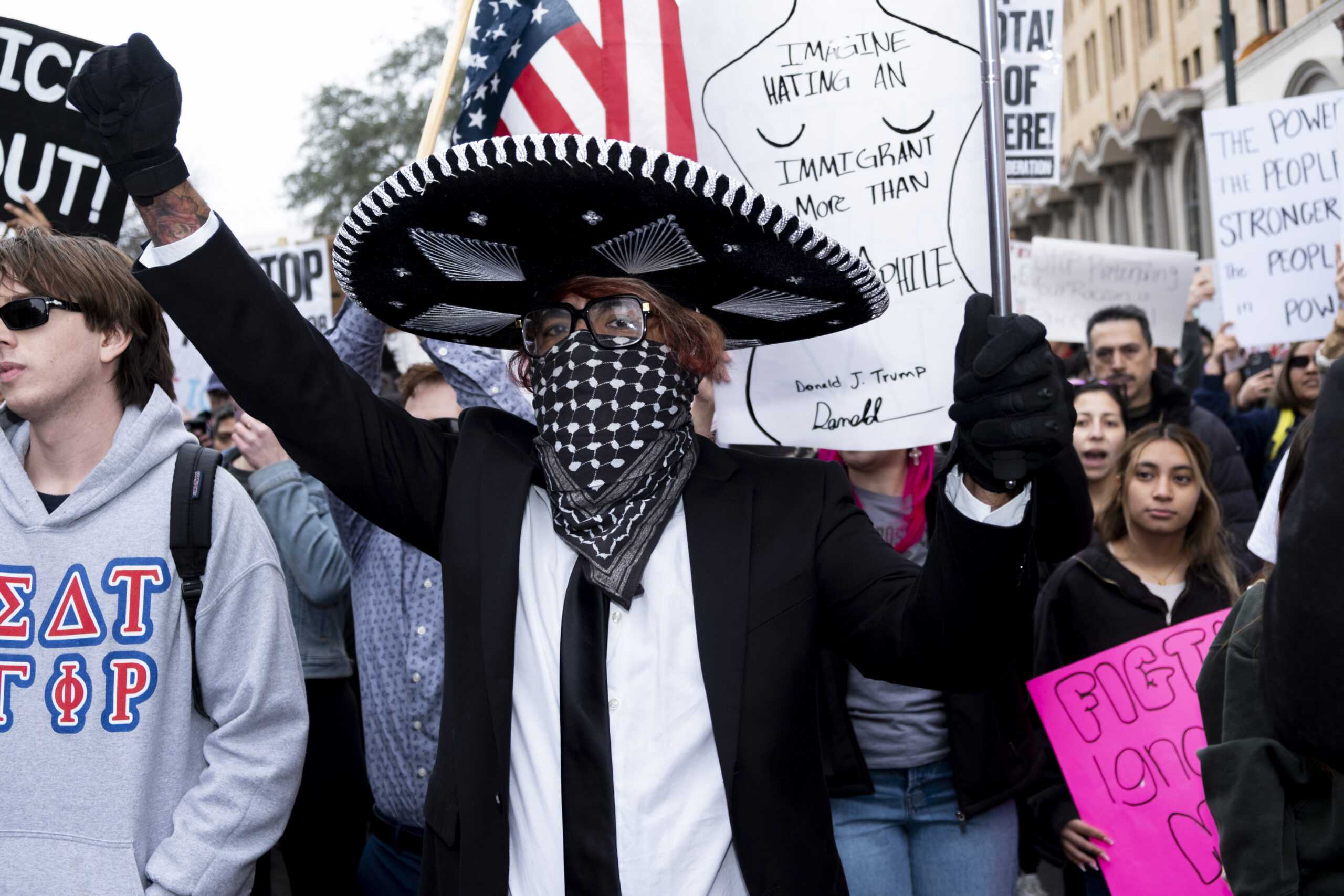 A protester chants as the first march starts on the corner of E Travis and Navarro on Friday as a part of a protest against recent fatal shootings involving federal agents in Minneapolis. Photo by Jacob R. Lopez.