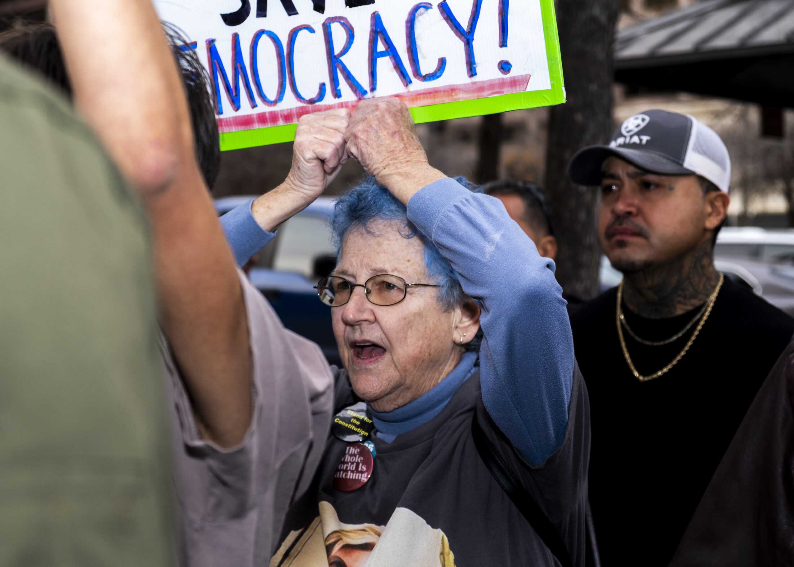 A protester holds up a sign as she marches through N St. Marys Friday. Photo by Jacob R. Lopez.