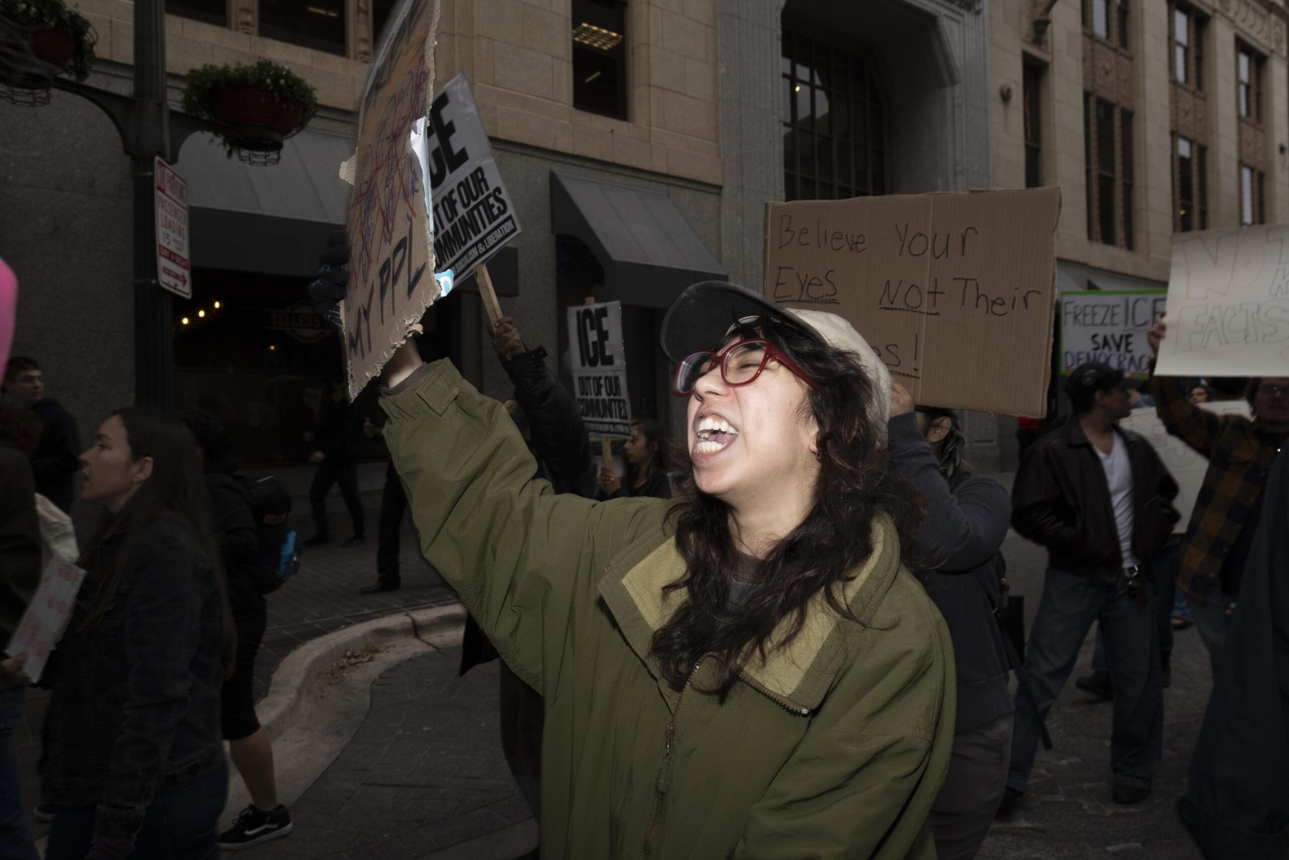 A protester marches down N St. Mary's as hundreds gathered in protest against recent fatal shootings involving federal agents in Minneapolis. Photo by Jacob R. Lopez.