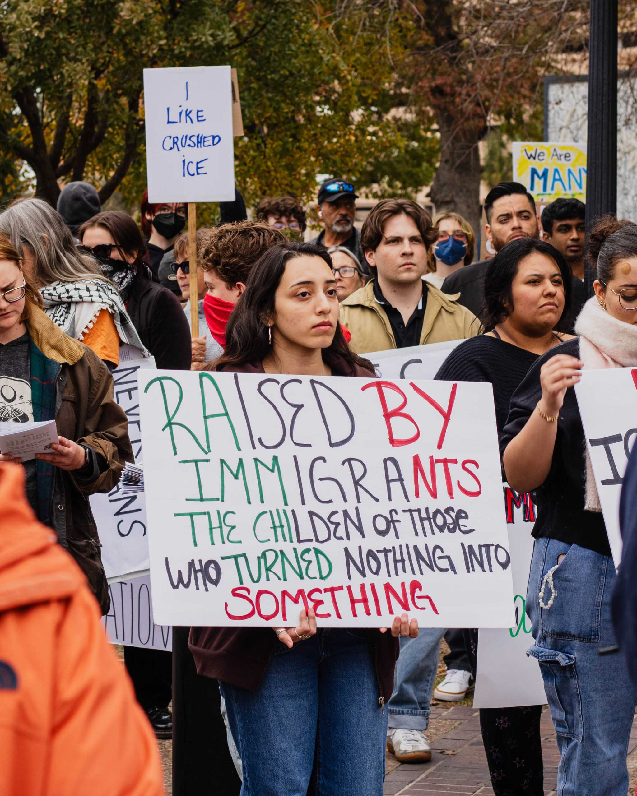 Business Administration major Alexis Carazo Ruiz holds a sign at Travis Park Friday. Photo by Hailey Vilegas.